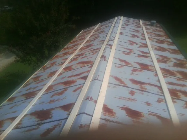 Rusted metal roof panels with new wood purlins before replacement — Storm Damage Roof Repair in Mc Cutchenville by Roofing Brothers
